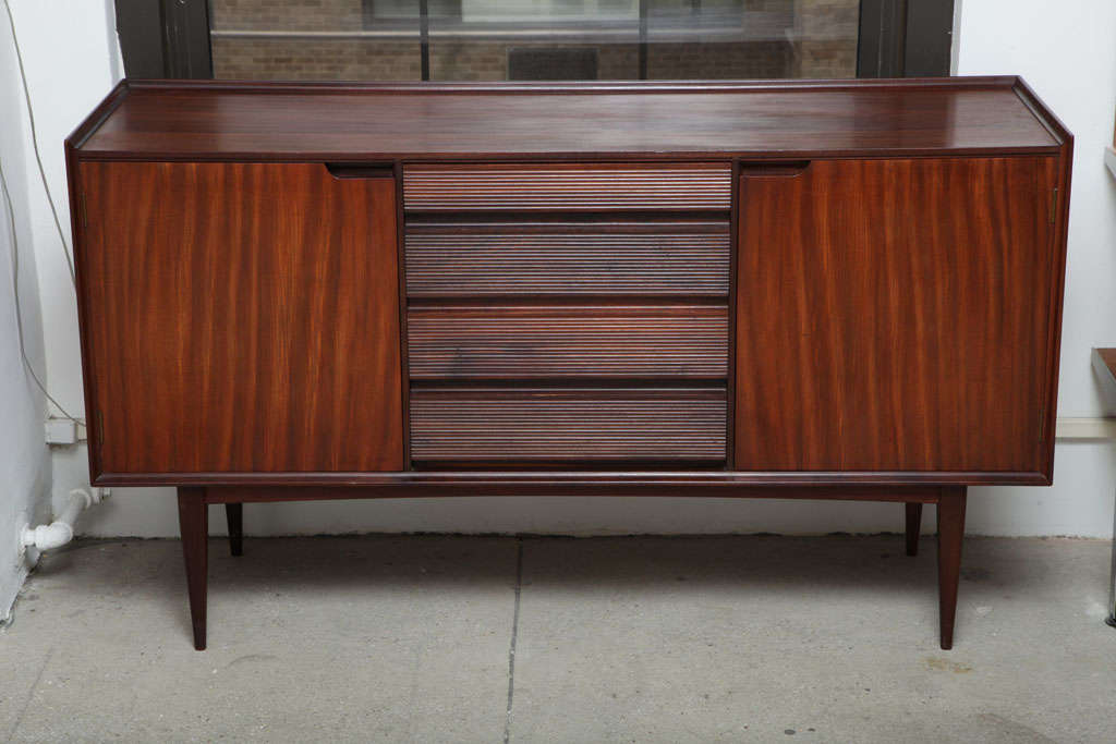 The sideboard is beautifully made with superb joinery detail by Fyne Ladye Furniture, Oxford, England and by British designer Richard Hornby. The design is simple and elegant, featuring Richard Hornby's trademark reed style drawers. The four drawers