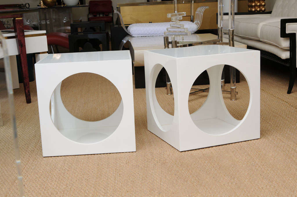 Special Custom white glass tops these chic and sculptural end tables. They are white lacquered over wood. Sculptural and open are the trademarks of these super end/side tables... They are fun, yet sophisticated at the same time...