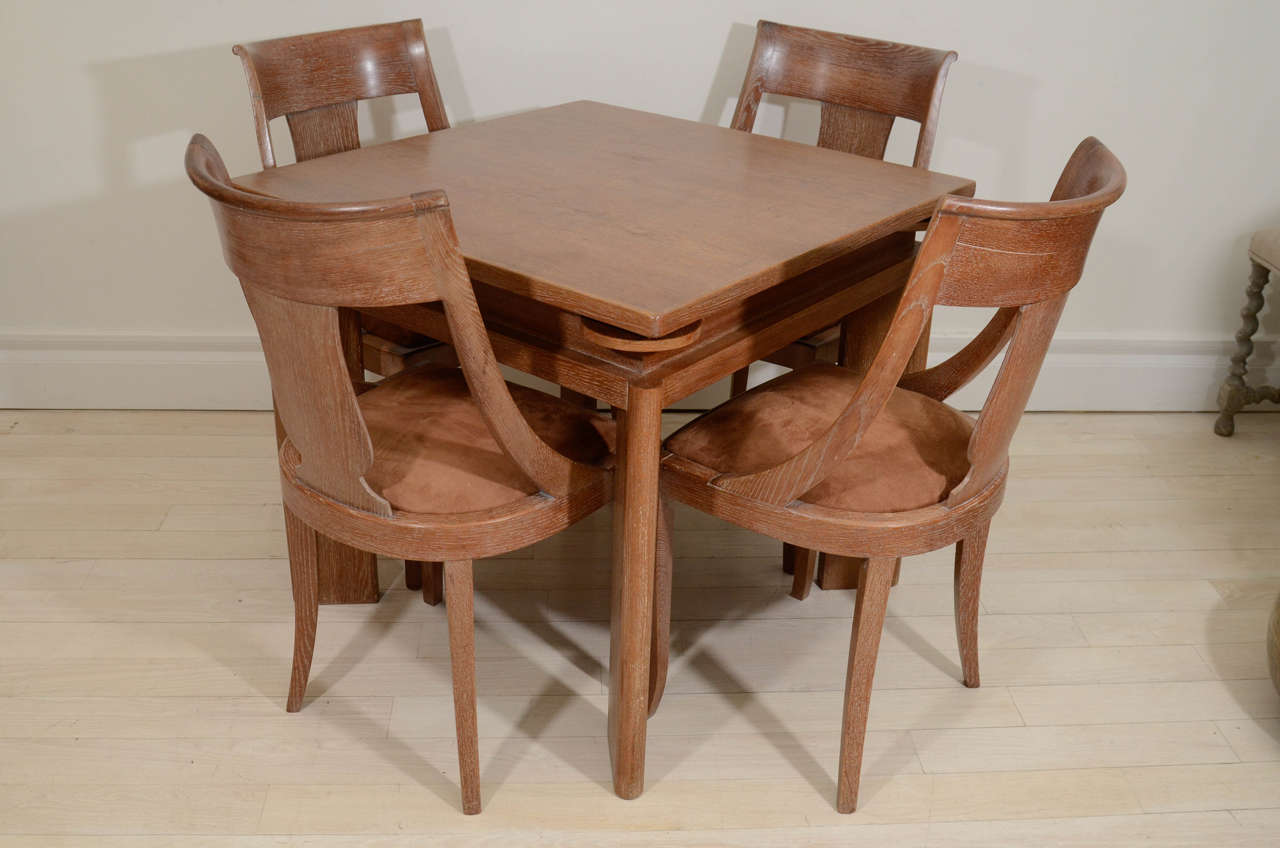 Cerused oak games table with removable top, opening to a brown suede playing surface, drinks tirrettes, and four matching curved back chairs.