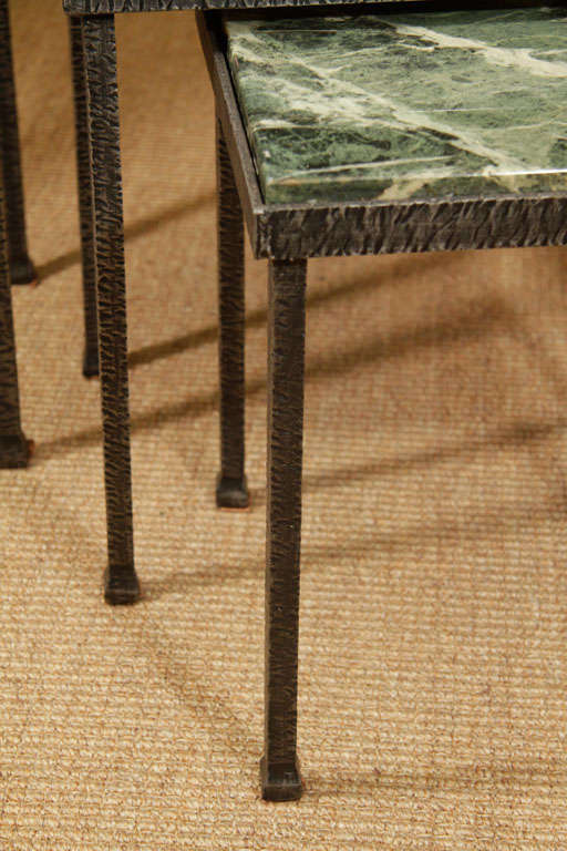 Set of three iron nesting tables with marble tops on square legs