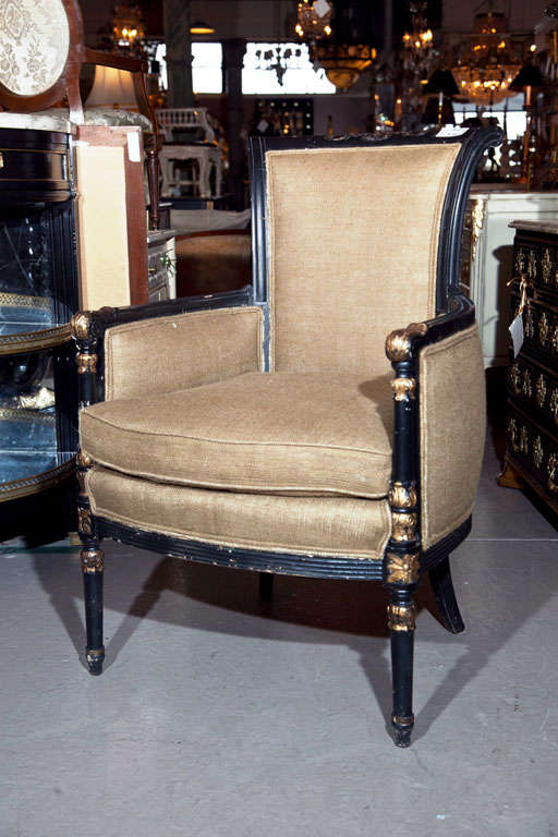 A pair of ebony and gilt paint decorated Maison Jansen armchairs. Each with a Louis XVI Style leg leading to a burlap newly upholstered chair.