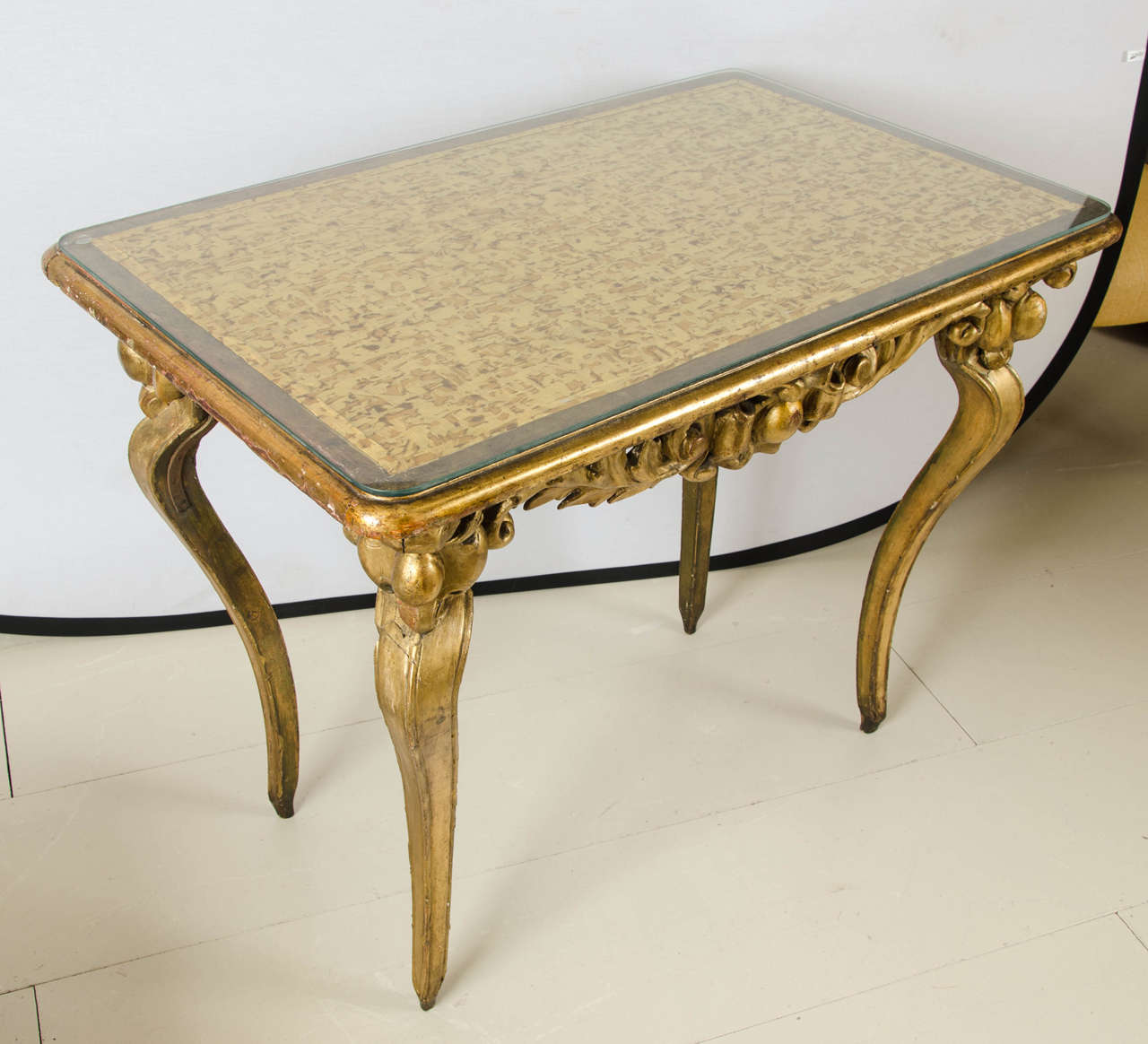 Italian giltwood center table with later Japanese silk top.