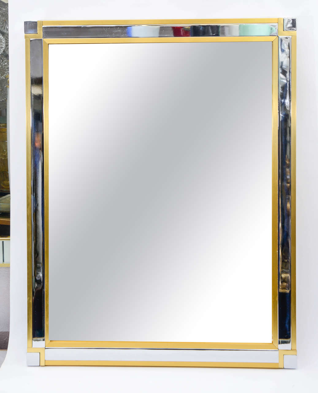 Mirror surrounding with brass and chrome-plated metal.
