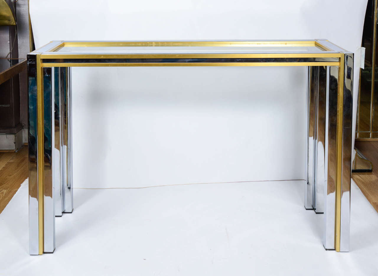 Console table with glass, brass and chrome-plated metal.