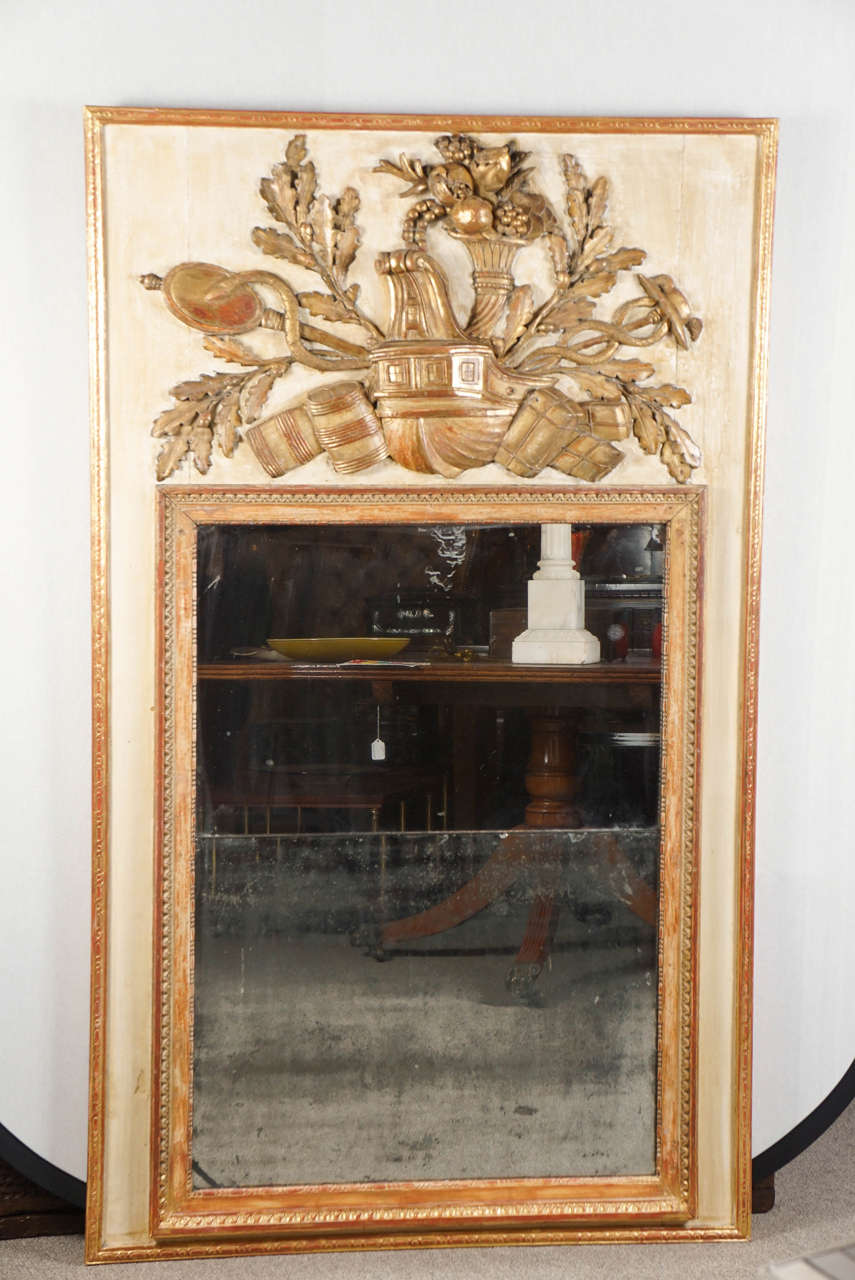 French trumeau mirror with unusual carved decorations and original glass.