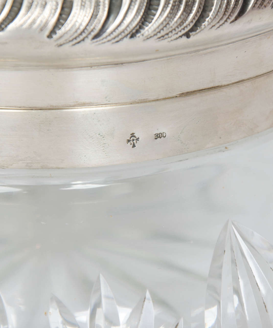 Extra large decorative cut-glass bowl with silver top.