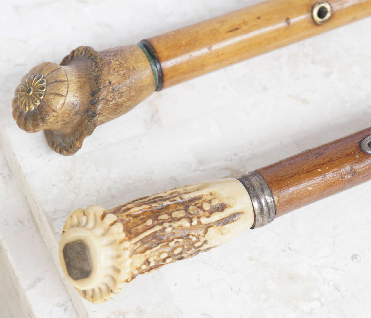 two French walking canes from the 19th century with concealed knives and Staghorn handles 

One has the dagger on the bottom of the cane and is made out of a tree branch, the other is pear wood with a 3