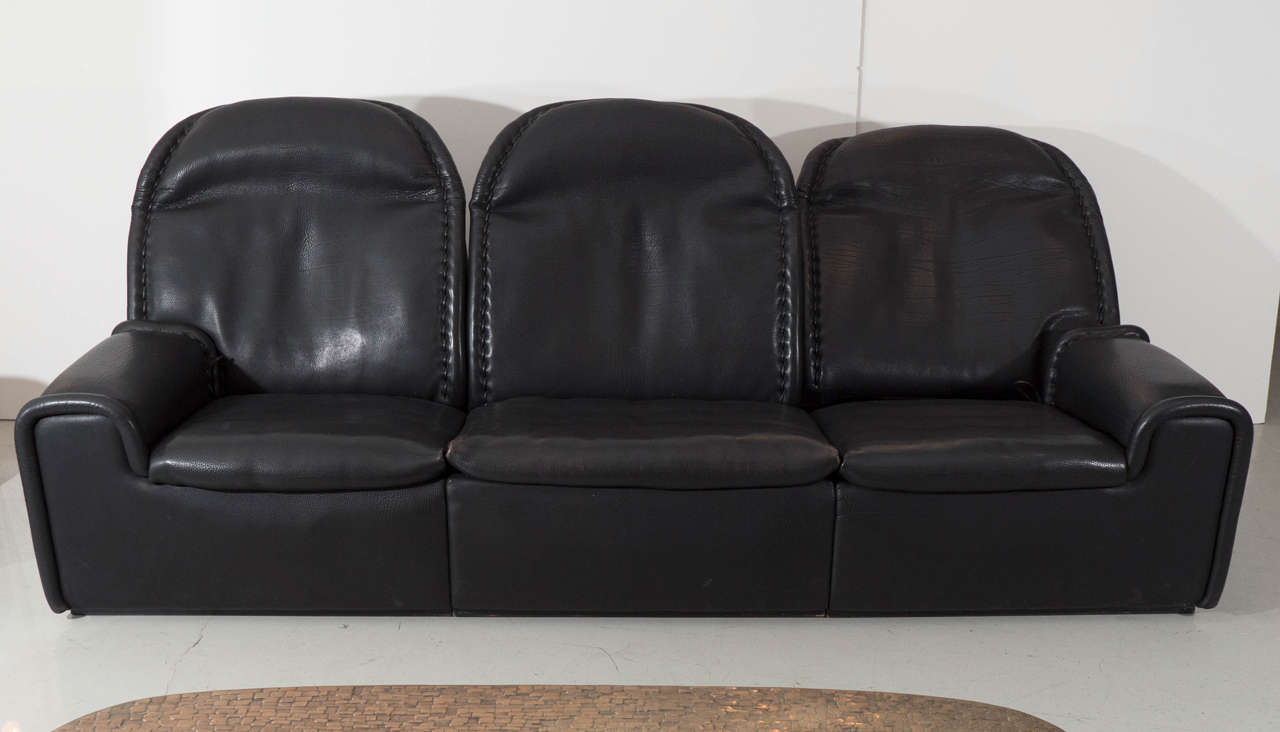 Unique sofa made from thick bull leather with three pull-up headrests. All three seats recline either separately or together. Height with headrest up is 37.5
