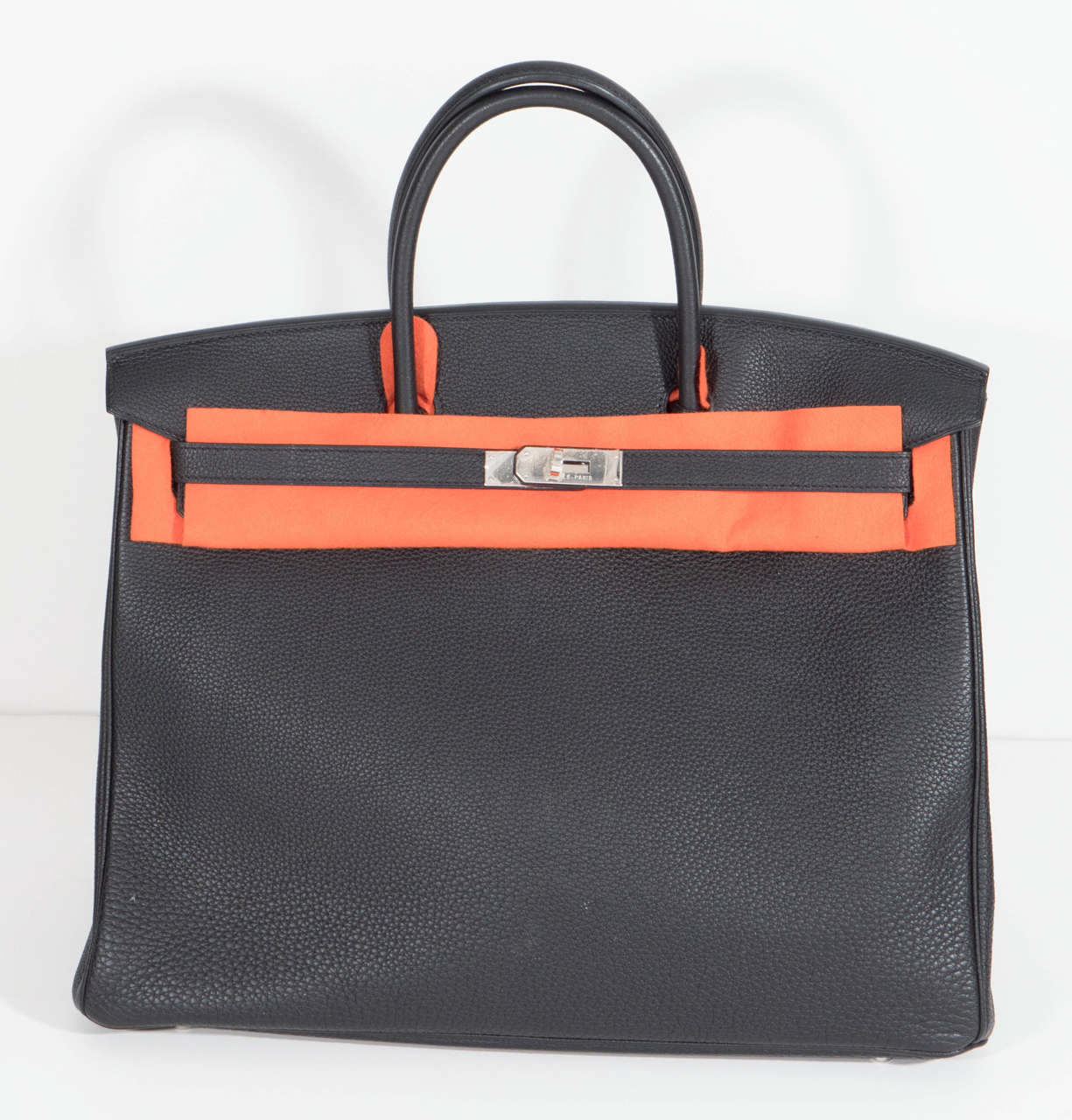 The ultimate status symbol by Hermes, the 40 Birkin bag in black Togo leather with Palladium Hardware, 2008. Date stamped L in a square. Never used. Has original dust bag, rain bag, keys and lock with own dust bag and Hermes care guide. No need to