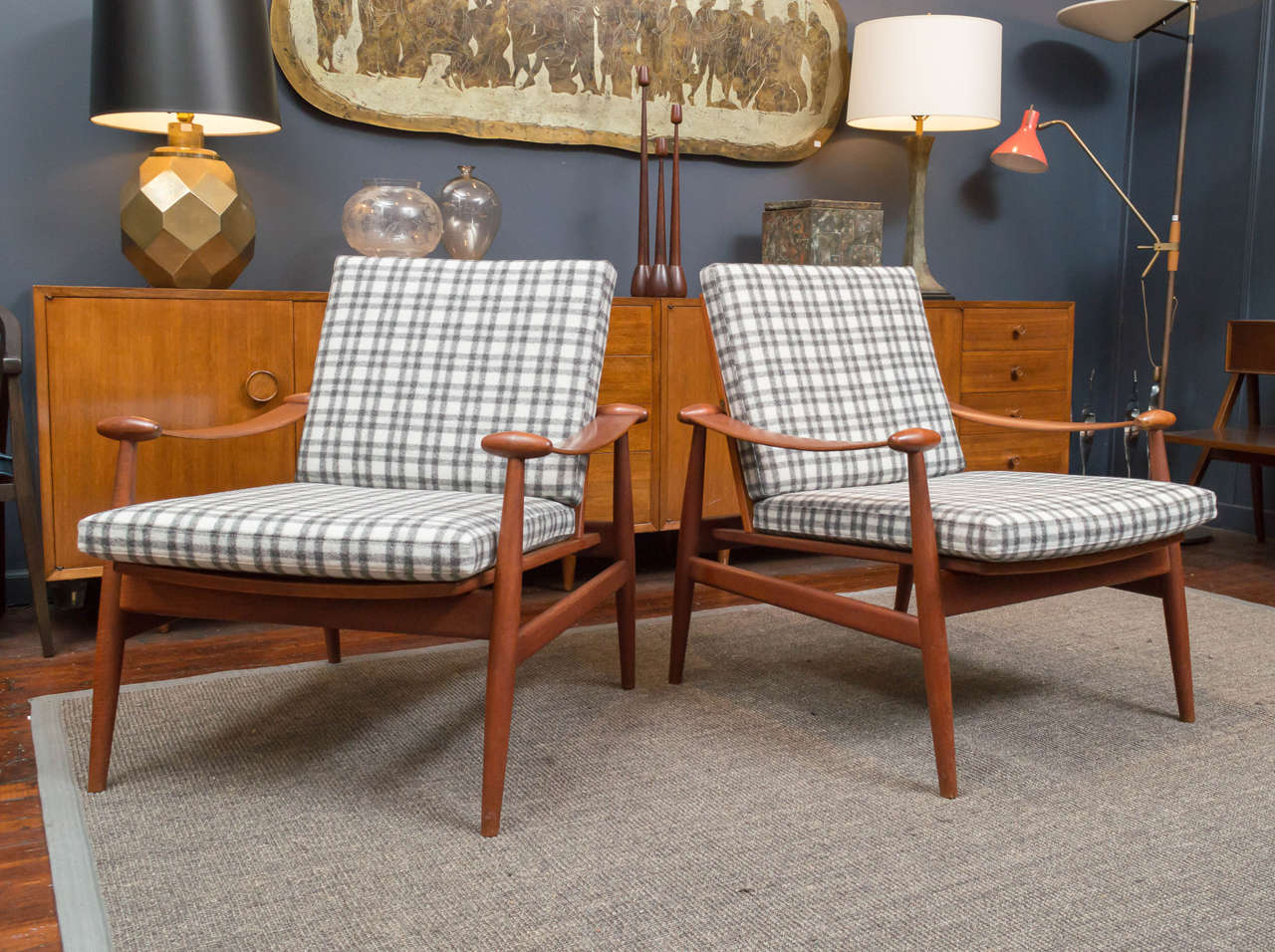 Finn Juhl design model #133 lounge chairs.
Sculpted frames made from solid teak with newly upholstered plaid wool cushions. 
Manufactured by FD, Denmark. In excellent vintage condition, stamped.