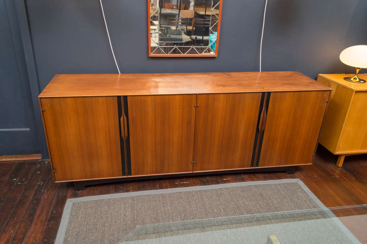 High quality design and construction walnut and ebony credenza.
 Designed by John Kapel for Glenn furniture company, labeled.
Very good original condition with fitted interiors.