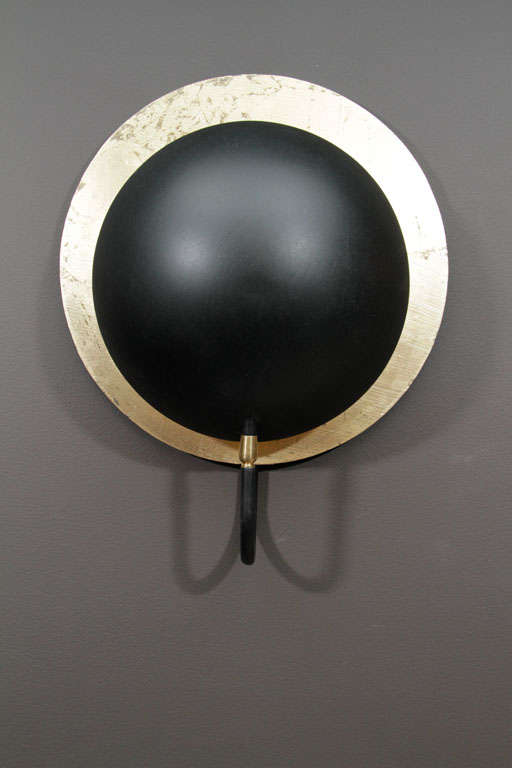 Gold and silver metallic and black finish wall sconce juxtaposes solar and lunar effects. Hand-made of metal. (40W)
