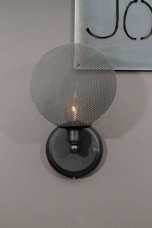White and black finished wall sconces made of perforated metal diffusers. (40W)