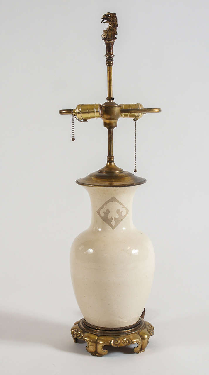 Beautiful Chinese Ming Dynasty (1368–1644) Cizhou ware baluster form vase having Ding style white slip glaze with double sgraffito gray celadon design at neck and gilt bronze base and top mounts for lamp conversion, France, circa 1910.  Griffin head