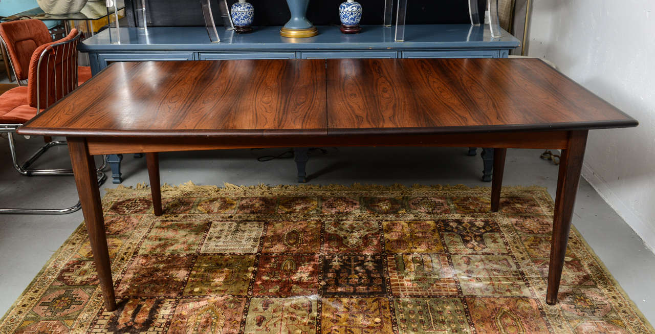 Beautiful Rosewood and Walnut Dining tables with built in leaves.  1960s Denmark.  Measurement below is without leaves in place.  Each leaf is 26
