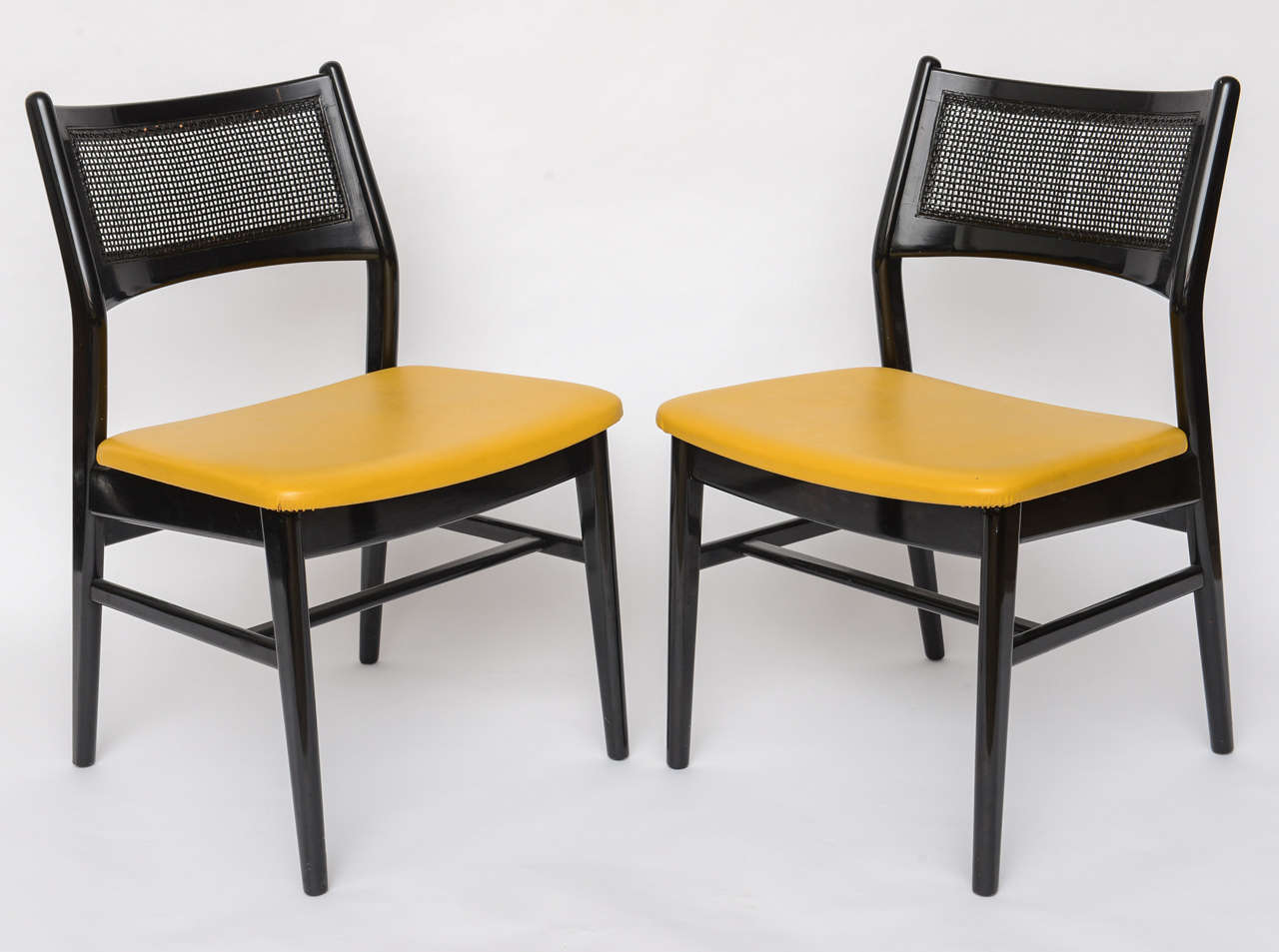 Beautiful black lacquer and cane dining room chairs by DUX.