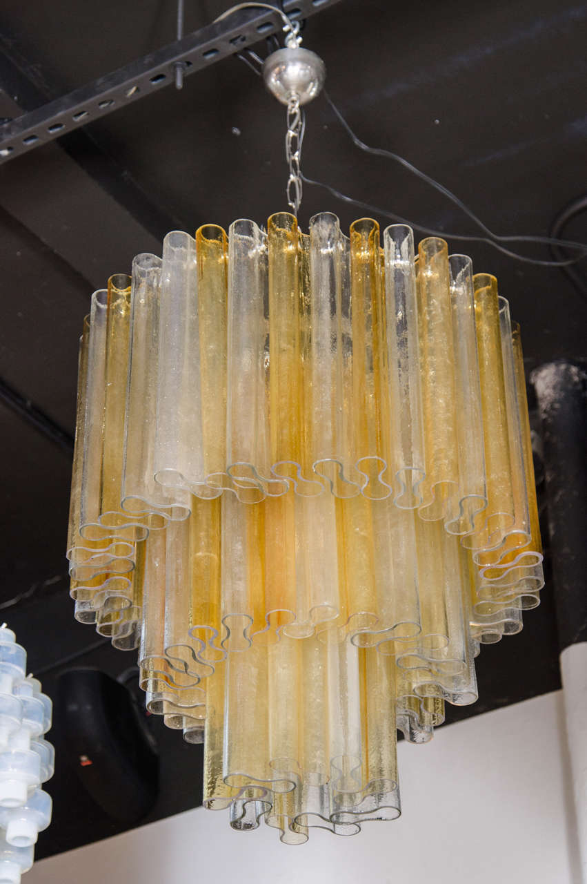 Exquisite Mid-Century Modernist three tier chandelier by Barovier e Toso.  This stunning chandelier features numerous hand blown venini glass strips that have a folded design to them, giving each strip an organic 'Figure 8' feeling which gives this