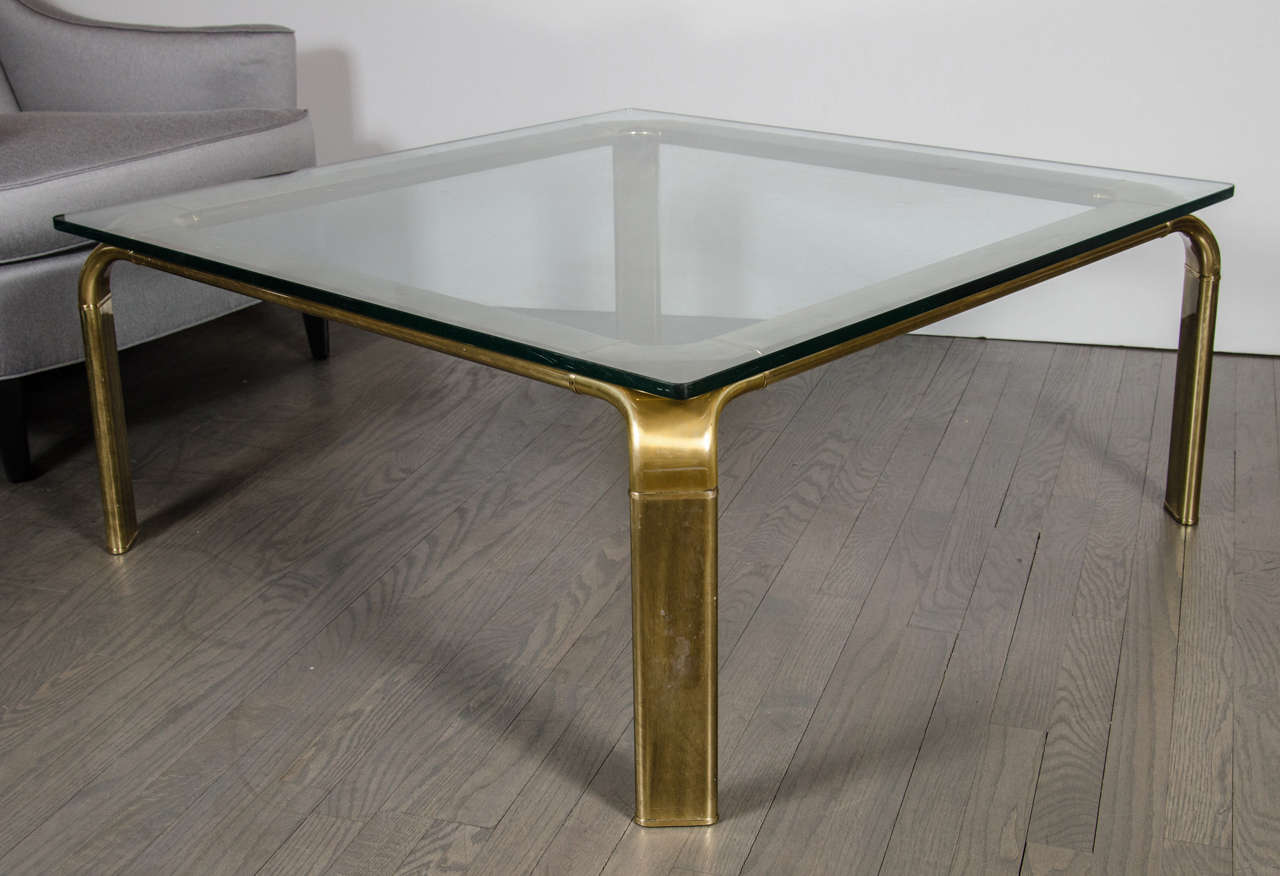 This outstanding Mid-Century Modern square cocktail table in the manner of Mastercraft consists of a 