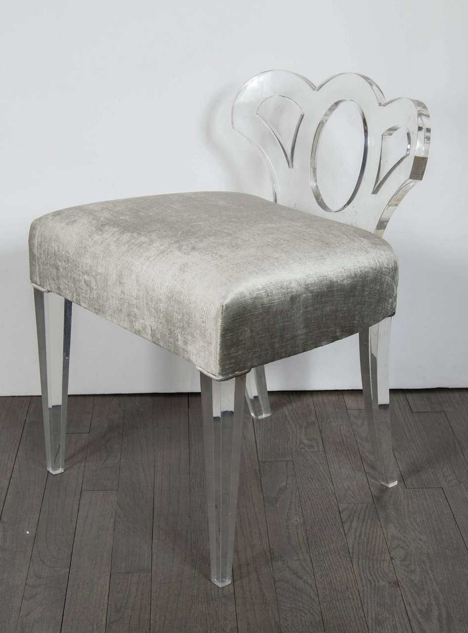 Elegant 1940's Hollywood lucite stool by Grosfeld House newly upholstered in a luxe oyster velvet.  The stool has squared tapered front legs and slightly sloped back legs all in lucite, as well as a lucite low back with a stylized scroll design..
