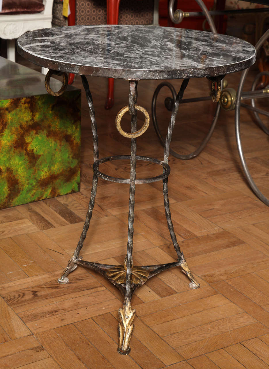 French A Wrought Iron and Parcel Gilt Decorated Marble Topped Gueridon For Sale