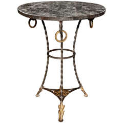 A Wrought Iron and Parcel Gilt Decorated Marble Topped Gueridon