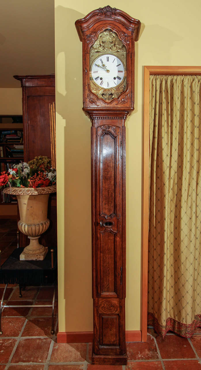 French Provincial Oak Tall Case Clock with Morbier movement

This is a fine grandfather clock with an oak case and nice patina.  

The top features a curved bonnet top with floral motif. The door around the movement is highly carved and fitted