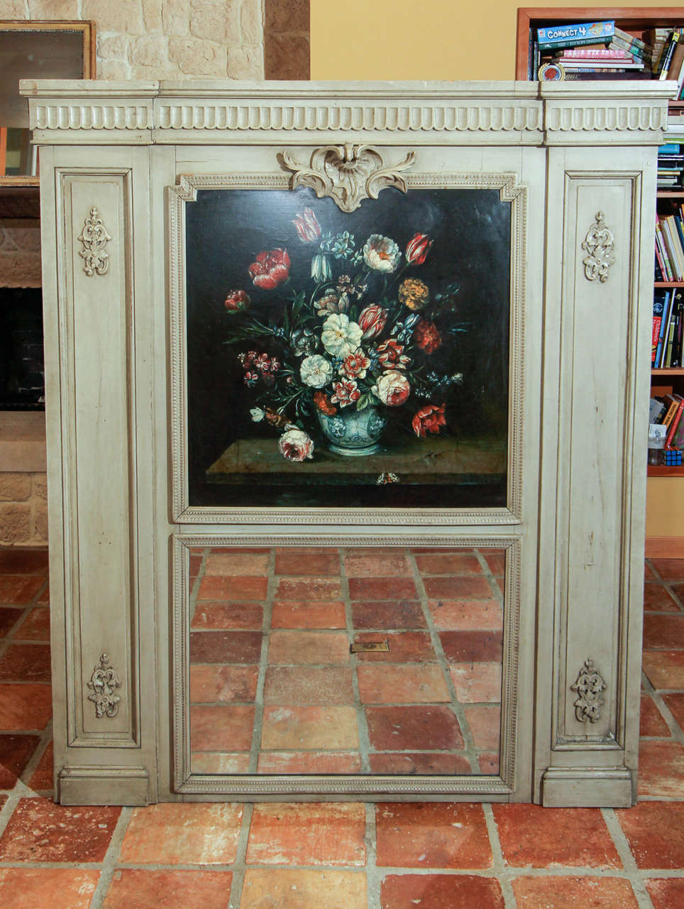 French Painted Trumeau Mirror

This a very decorative Louis XV style mirror.  

It features an oil on board floral still-life painting on the top and the original glass mirror on the bottom. 

The frame has two columns running up and down each