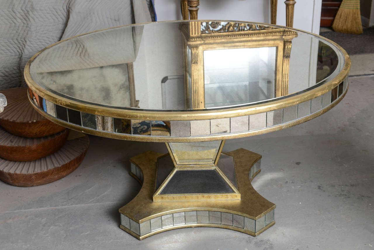 Superb pedestal round table with beveled mirror, giltwood and distressed mirrors.