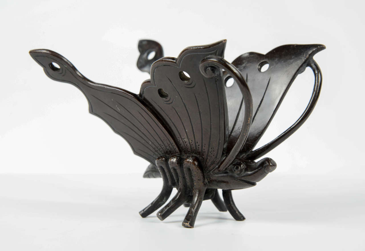 Stylized bronze butterfly.
Small accident on one wing.