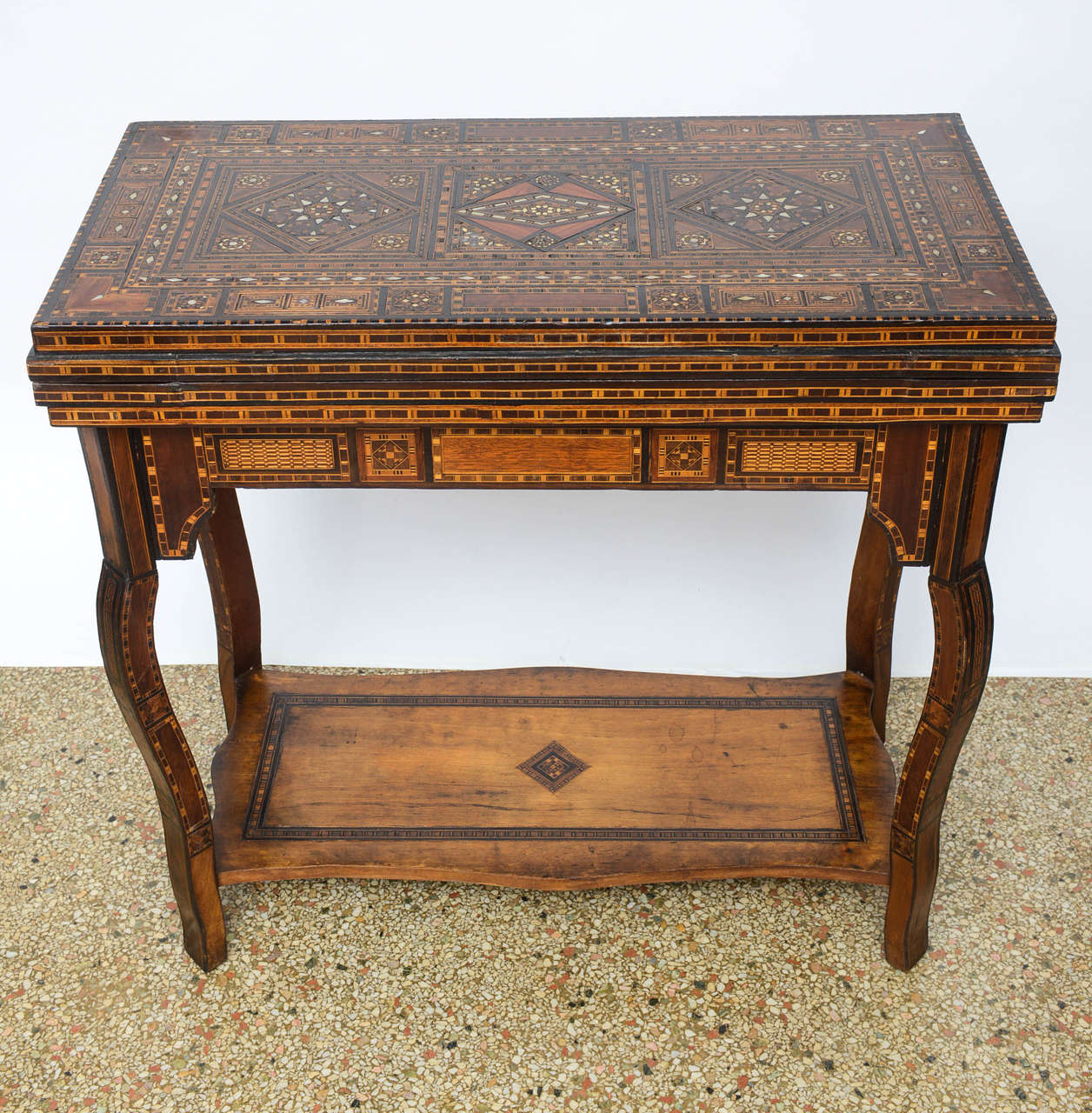 Moroccan multi-purpose games table/ console with shelf.  Table is narrow enough to be used as a console/ sofa table but when opened, it is inlaid for checkers, chess, backgammon & has a green felt top for playing cards or other games.  All the inlay