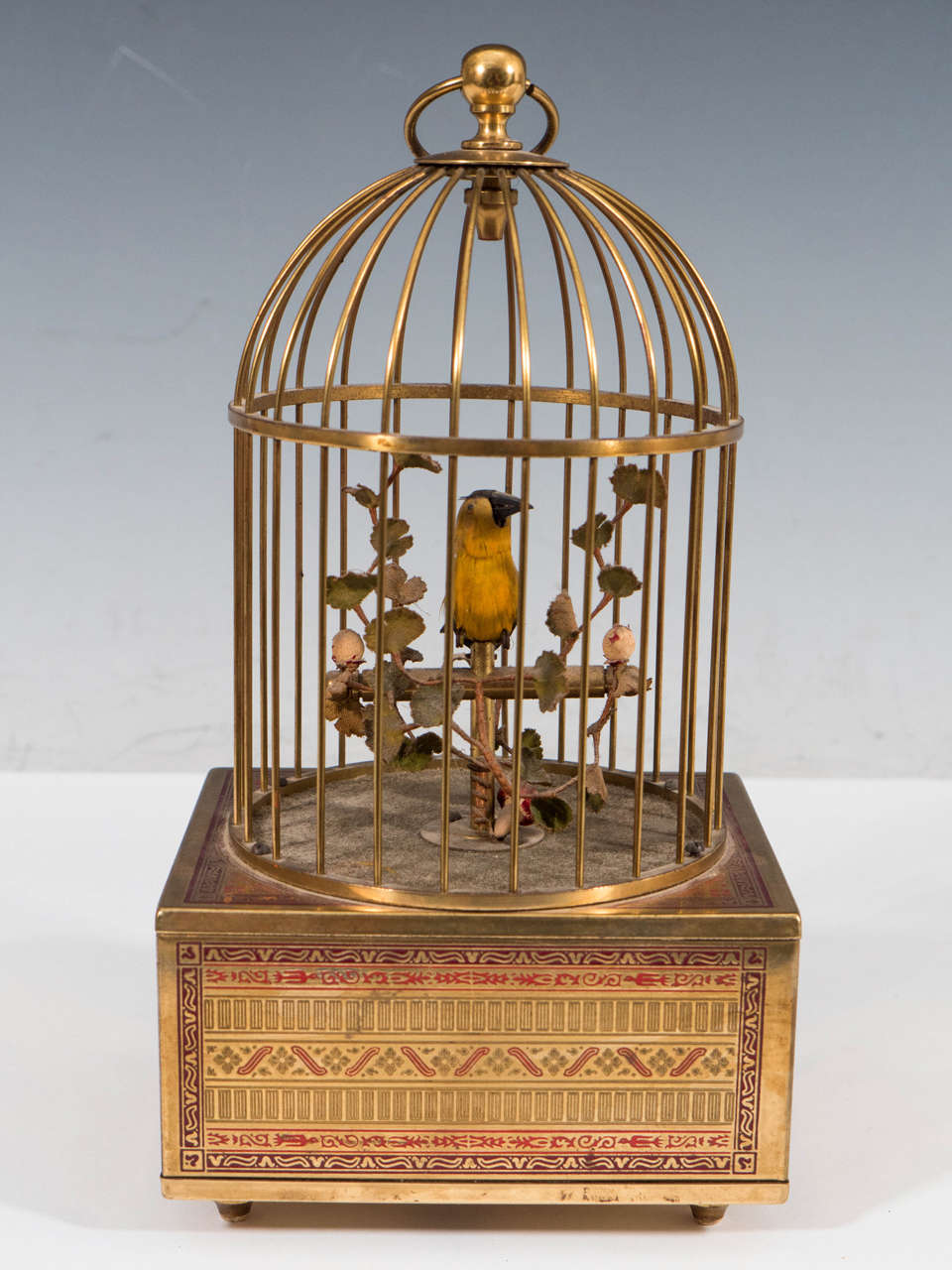 A vintage working automaton of a singing bird in a brass cage with etched detail, Germany, circa 1940. Good vintage condition with age appropriate wear and patina.