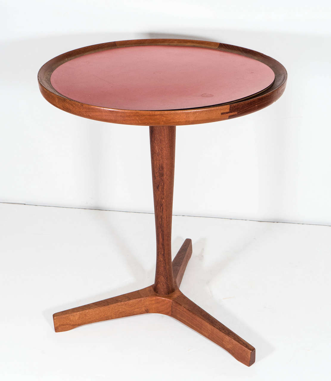 A Danish modern Hans Andersen teak side table with a round top and red laminate inset panel.