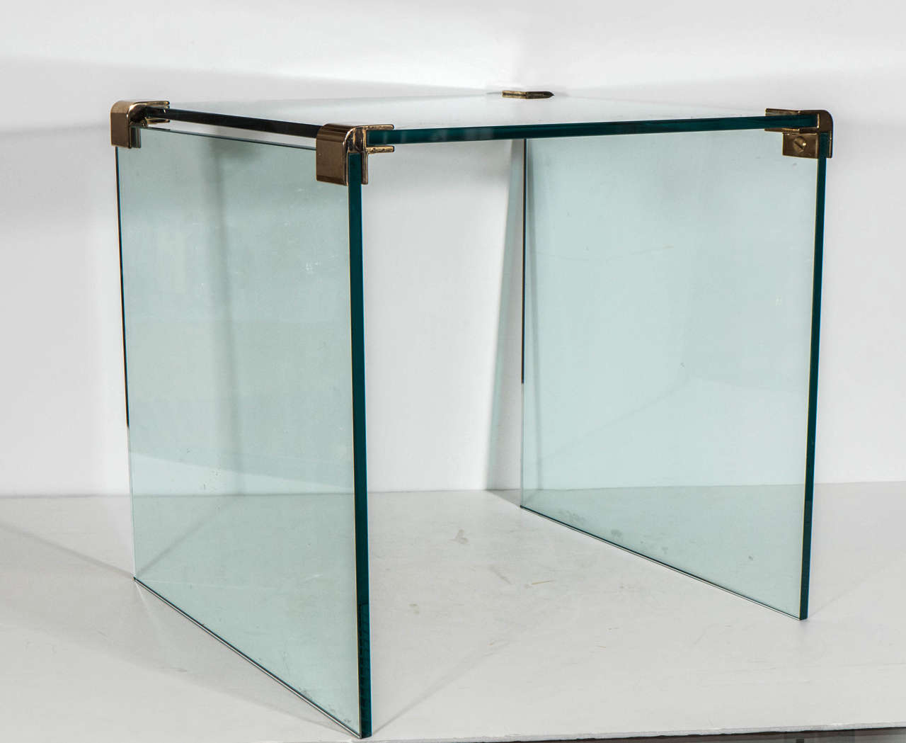 A vintage pair of glass end or side tables with brass fittings by Leon Rosen for Pace Collection, circa 1970s.
