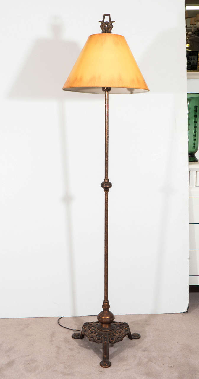 A completely original Arts and Crafts hammered copper floor lamp on stylized base with tripod foot. Takes two 60watt Edison bulbs, with double cluster sockets; newly rewired to US standard. Good vintage condition with age appropriate wear and patina.