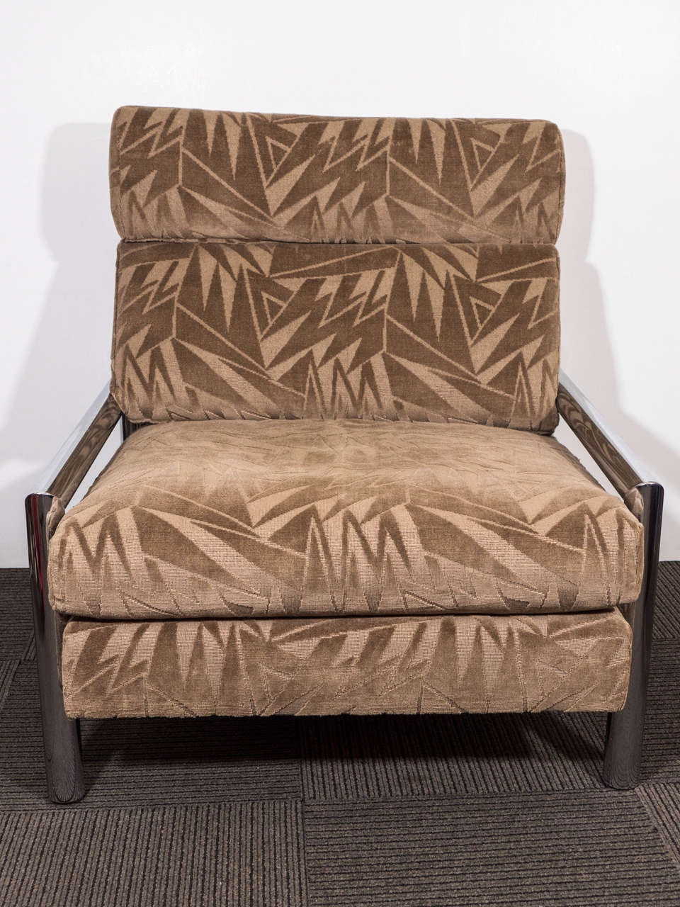 A vintage armchair with chrome body and newly reupholstered in taupe cut velvet.