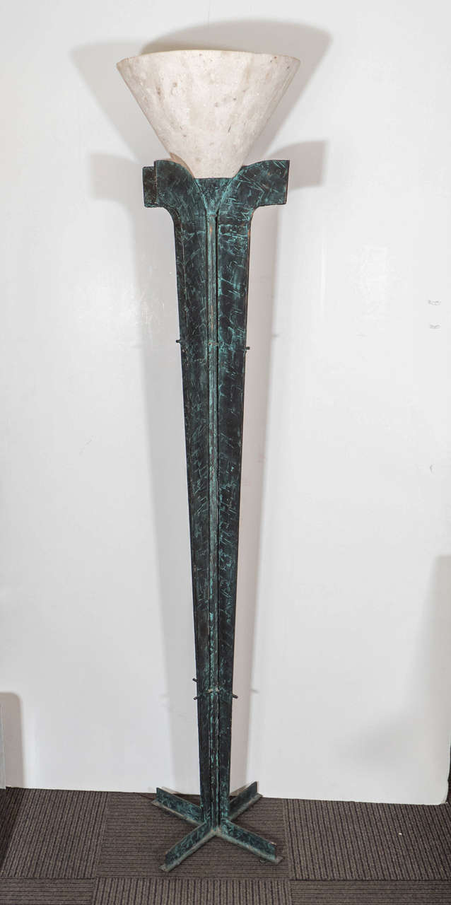 A vintage torchiere floor lamp, produced in France, circa 1970s, with cast stone shade over patinated bronze body. A very unusual piece, produced in the Brutalist manner, with classical Art Deco elements. Takes one Edison bulb, wiring US standard.