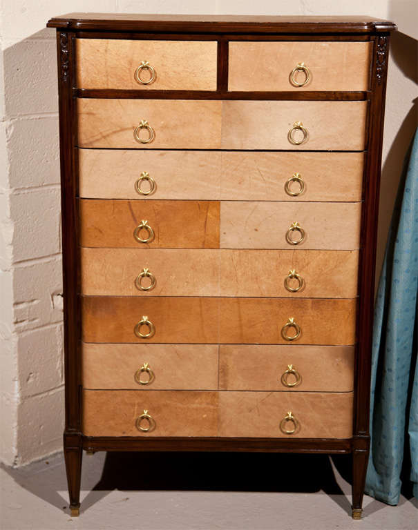 French Art Deco style lingerie chest, circa 1940, mahogany case with parchment veneer, raised on squared tapering legs ending in brass caps.