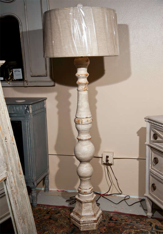 A pair of tall standing lamps paint decorated Swedish style. Each with a new shape and recently wired.
