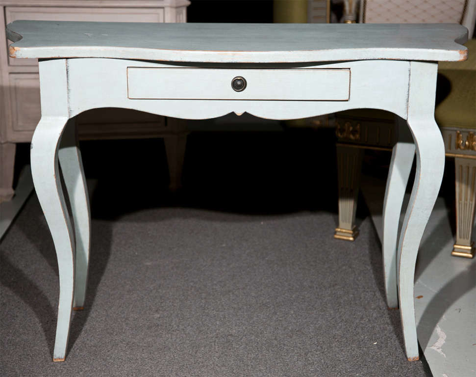 A very chic Swedish Rococo style baby-blue painted console table, serpentine top over a scalloped frieze fitted with a single drawer, raised on cabriole legs.