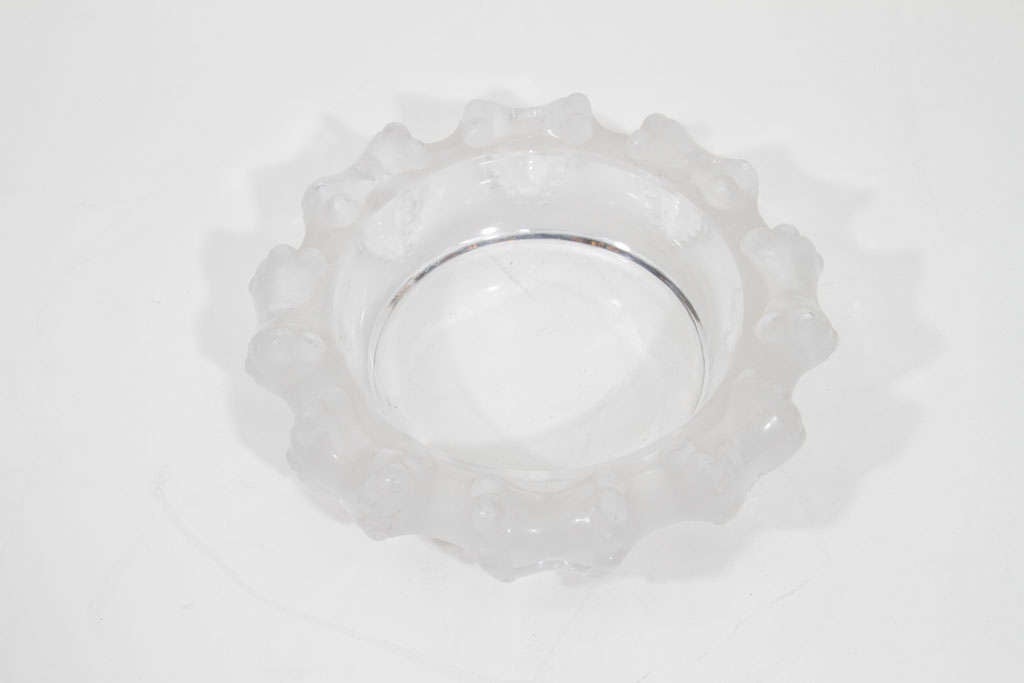 Exquisite frosted glass relief bowl by Lalique features eight stylized octopus arms that wrap around the bowl's edge. Signed.