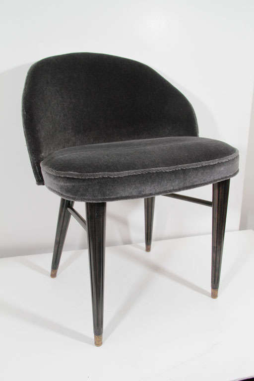 Modernist Mid-Century curved back vanity stool newly upholstered in  charcoal Mohair with antiqued brass nailheads and four ebonized Walnut carved, tapered legs.