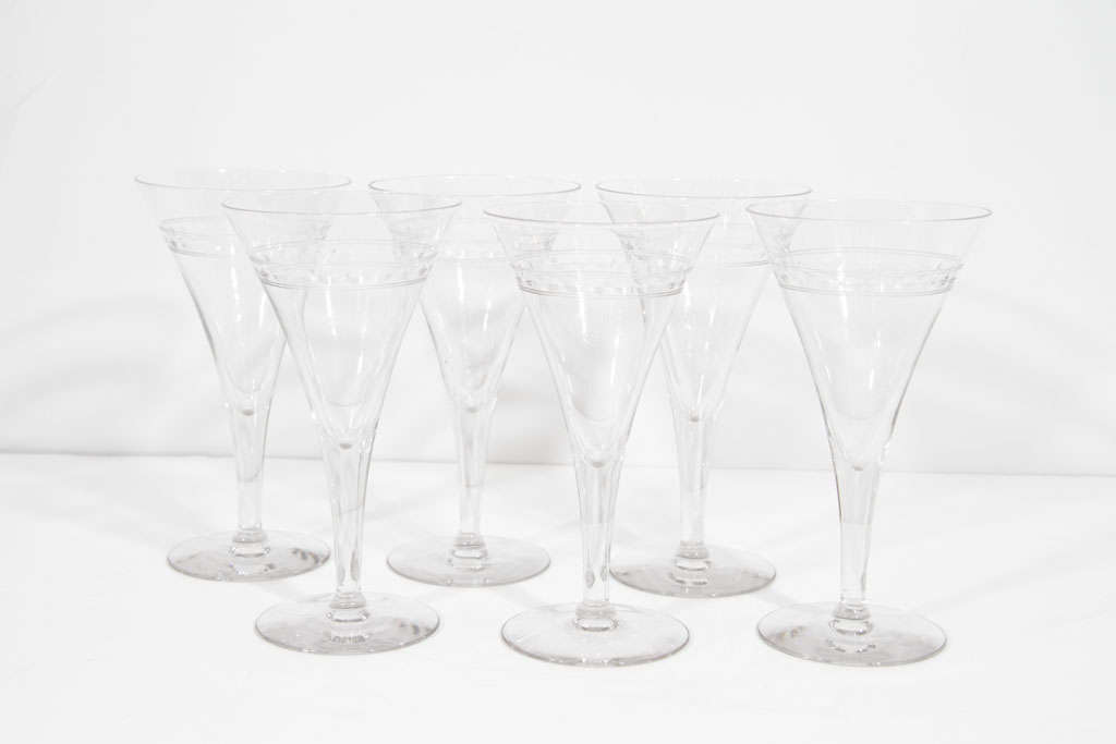 Elegant set of four glasses. Each glass features etched banding around a large opening that tapers to a fluted stem.