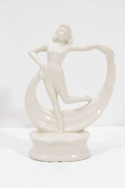 Art Deco dancing flapper ceramic sculpture features a delicate ivory craqueleur glaze. Dancer rests on a raised platform with a protruding lip, evocative of Art Deco architecture. Excellent condition.

America, Circa 1935

Dimensions: 
3.25