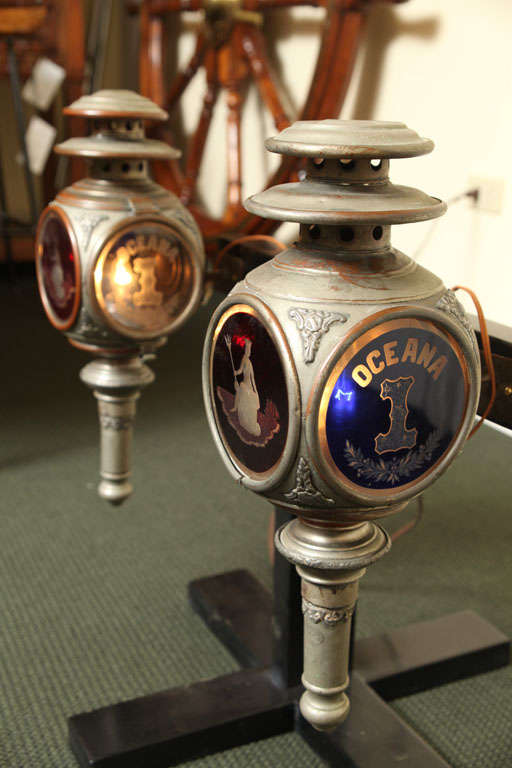Pair of Carriage lamps made by De Voursney New York. The lamps depicting a red etched glass figure of Neptune in the front, and Oceana on the sides