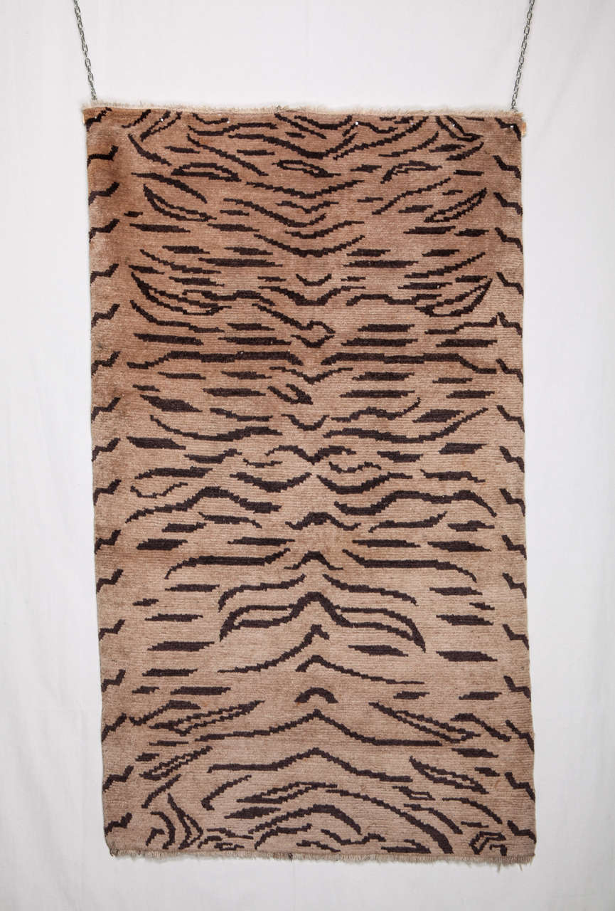 This rug is one of the fascinating and rare Tibetan Tiger Rugs. As a remarkable percentage, this Tiger design, consist of the naturalistic depiction of tiger pelt, with law degree of abstraction, intentionally woven in brown on walnut field, with a