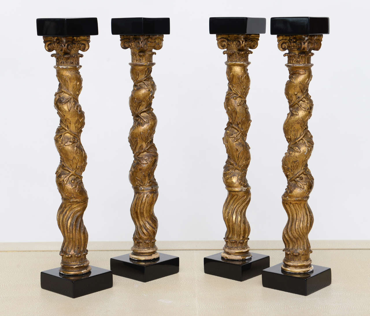 The giltwood carved columns with later ebonized base and caps, the columns 18th century.