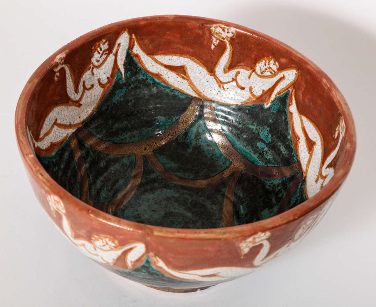 A French Art Deco Ceramic Centerpiece by Edouard Cazuax decorated with Stylized Reclining Nudes, holding Clusters of Grapes on both the interior and exterior walls of the Bowl.