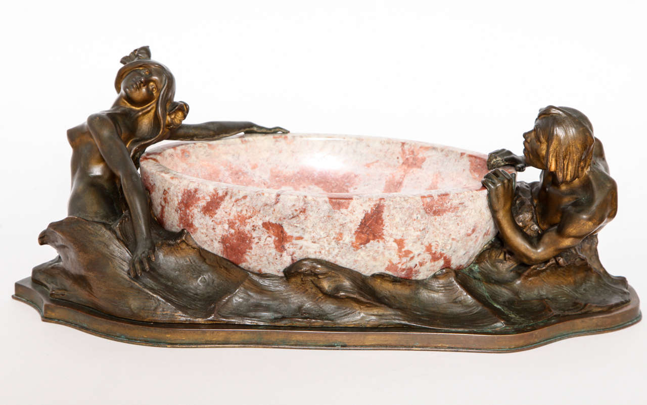 An Art Nouveau French Bronze and Marble Centerpiece with a 
Mermaid and Merman Anchoring a Marble Carved Oval Bowl,
circa 1900. Signed with F. Barbedienne Foundry Mark.
Attributed to Maurice Bouval.