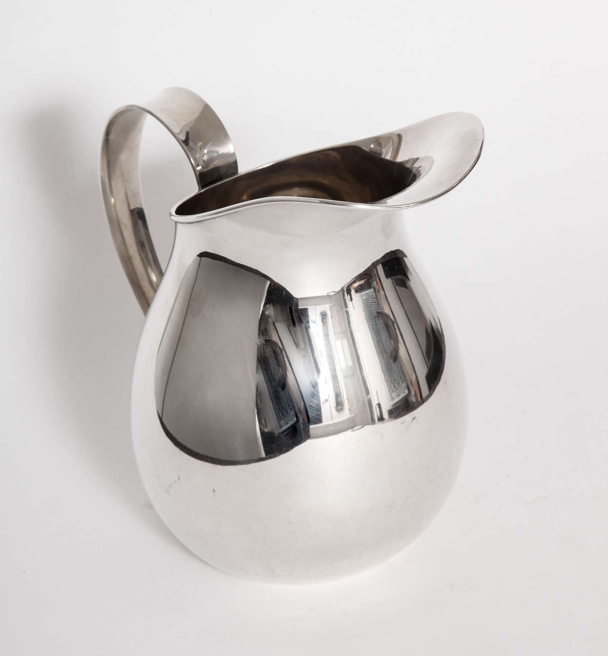 An Allan Adler hand-hammered sterling silver pitcher, circa 1955, Studio City California. Mint condition, marked on underside, Allan Adler, sterling.