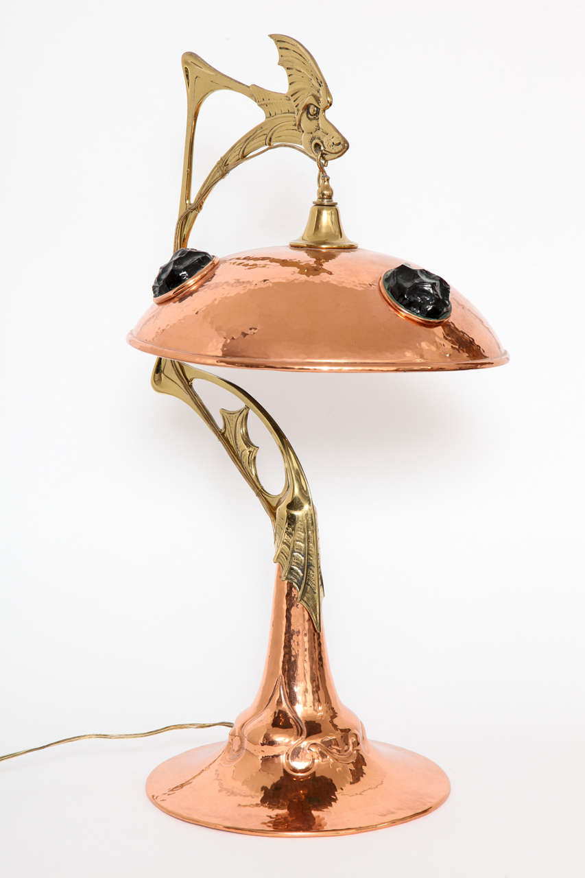A German Art Nouveau Hammered Copper, Brass and Glass,
Dragon Table Lamp, circa 1904.
